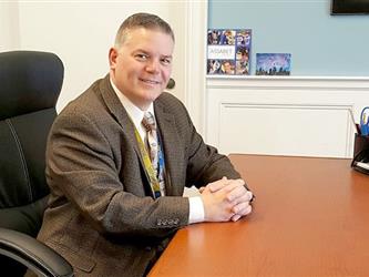 Superintendent-Director Ernest F. Houle at a desk