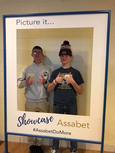 Visitors pose in polaroid-style photo frame