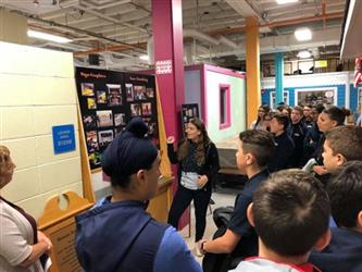 visitors in PD listen to a tour guide