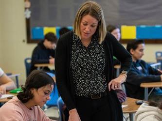A teacher assisting a student with work