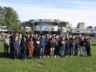 Students in a field in a group
