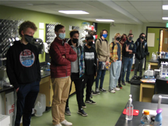 Students standing around a room