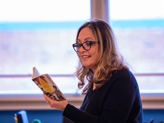 A teacher reading a book