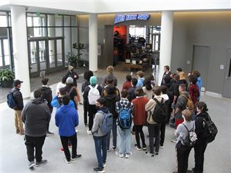 Students standing around in a large dispersed group 