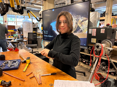 students using tools in a technical shop