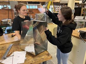 students working with sheet metal