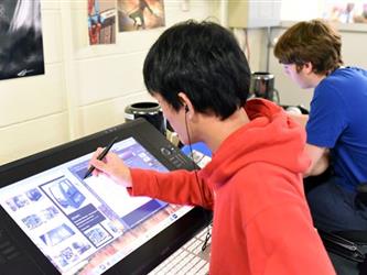 Student drawing on a tablet