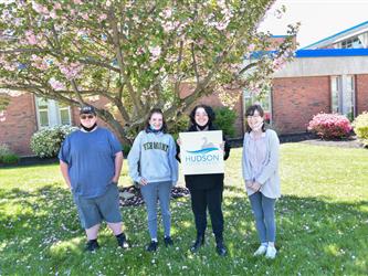 Students holding up a design project they worked on